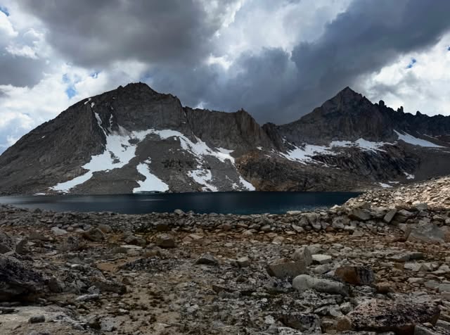 A mountain lake and granite peaks photographed by Harrison on the trail